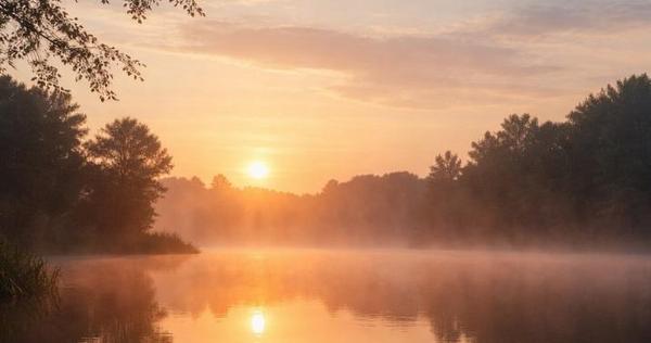 Peaceful sunrise over a calm lake with soft mist and trees, symbolizing comfort and reflection at funeral homes Tulsa, OK