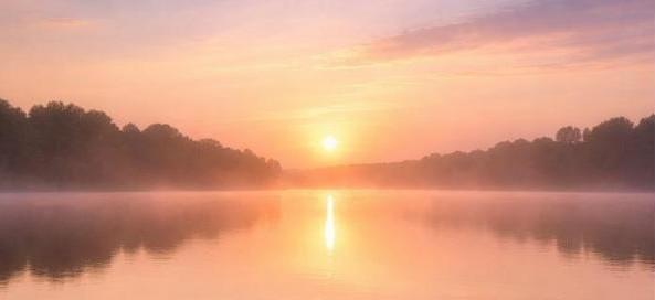 A peaceful sunrise over a misty lake, much like the compassionate care offered through cremation services in Tulsa, OK
